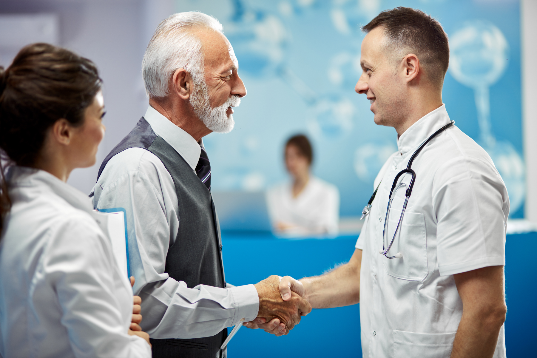 Doctor and businessman shaking hands